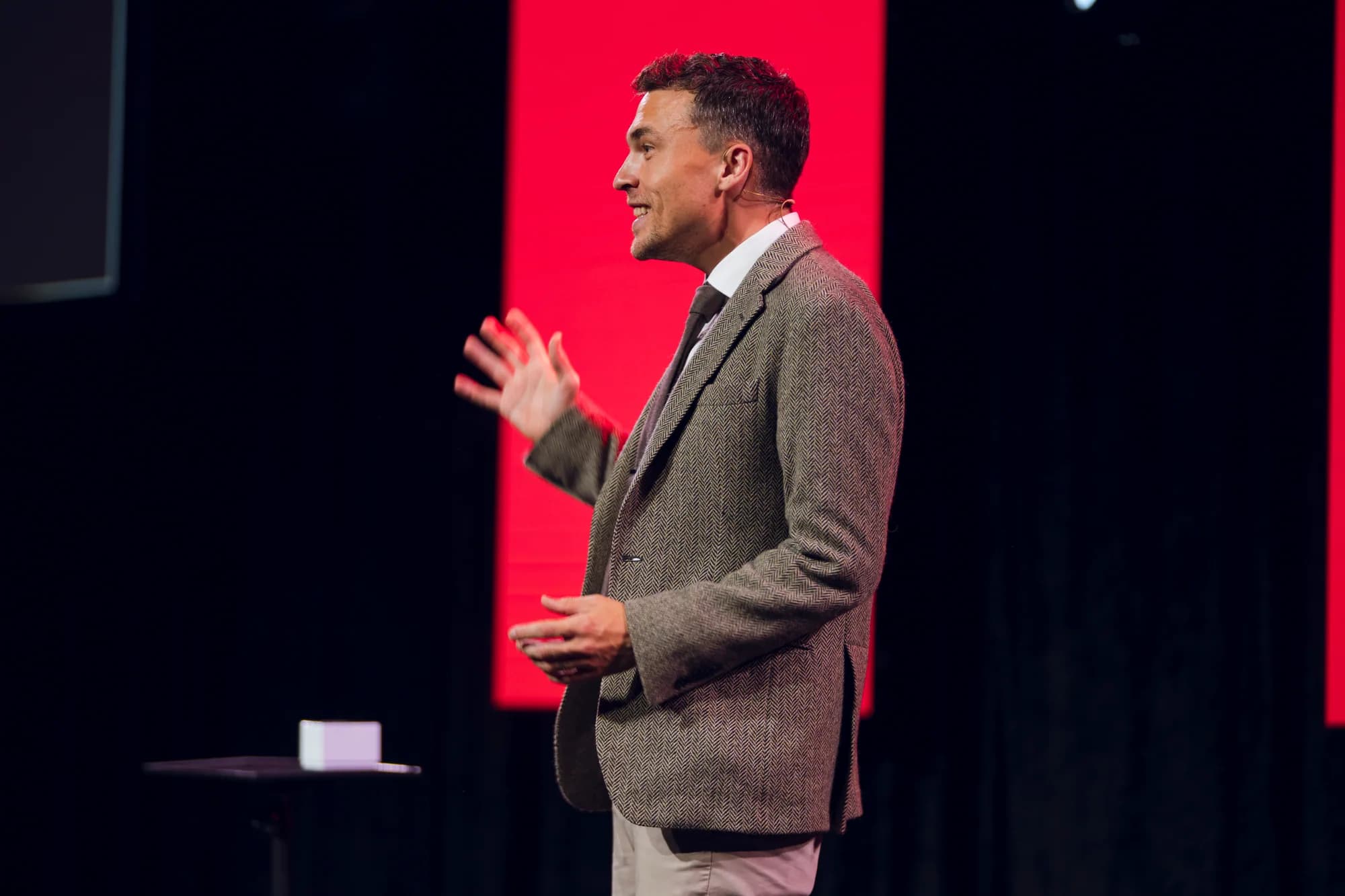 Andy Nunn presenting in profile on a corporate stage