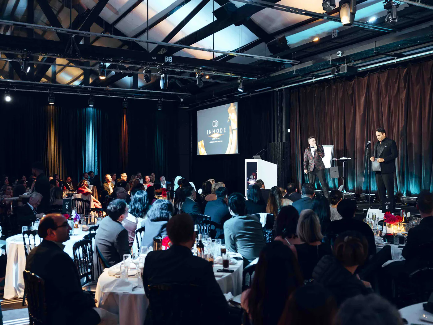 Andy Nunn presenting to guests in a black-tie Sydney corporate venue