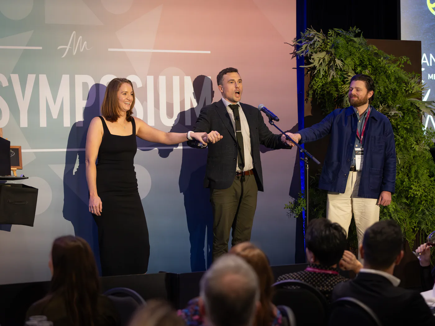 Andy Nunn creating a shared keynote moment with guests on a Sydney stage
