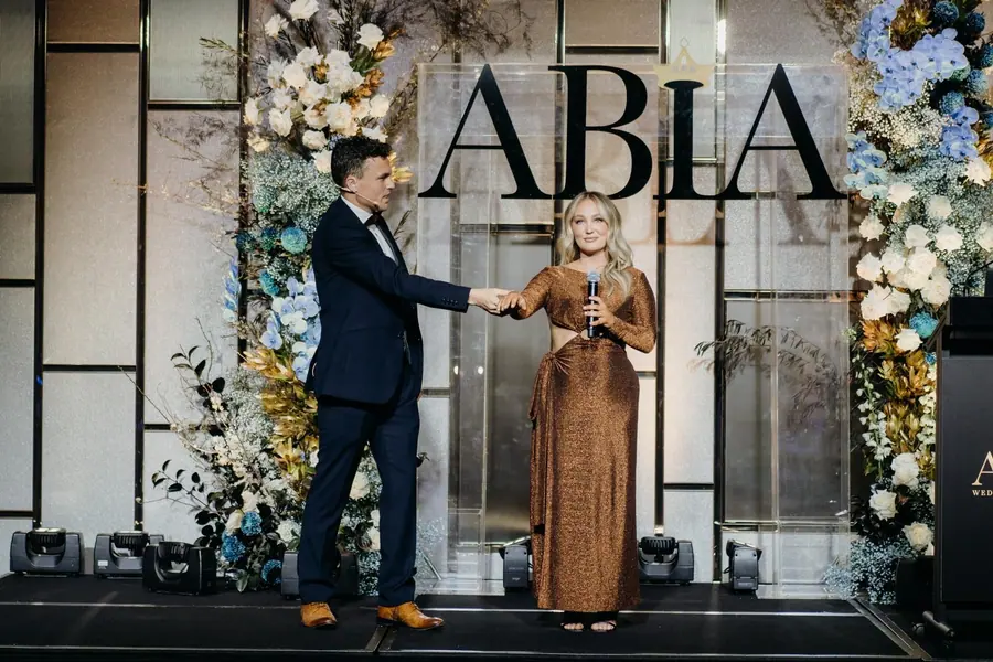 Andy Nunn involving a guest in an awards night stage performance