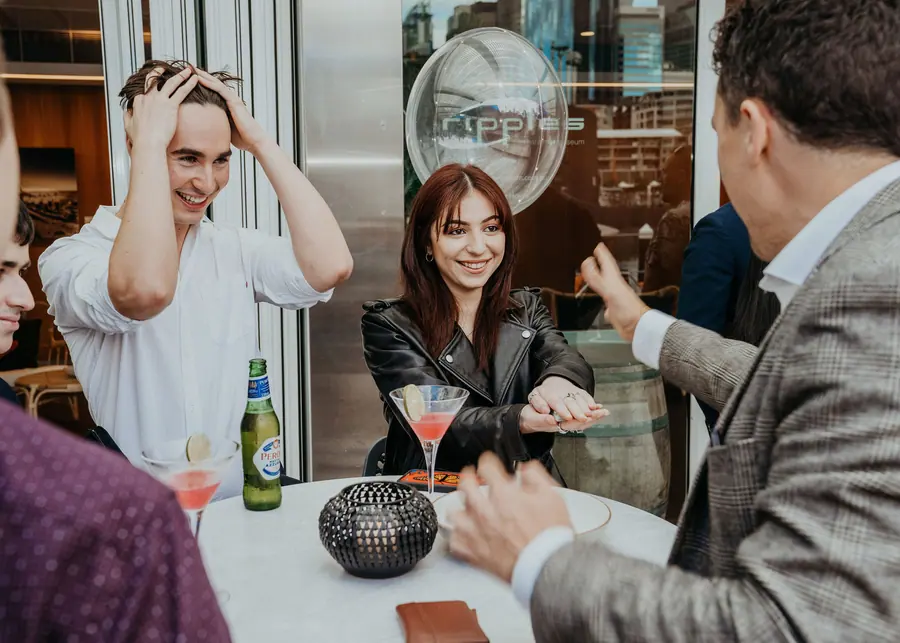 Cocktail event guests reacting to Andy Nunn's close-up mentalism in Sydney