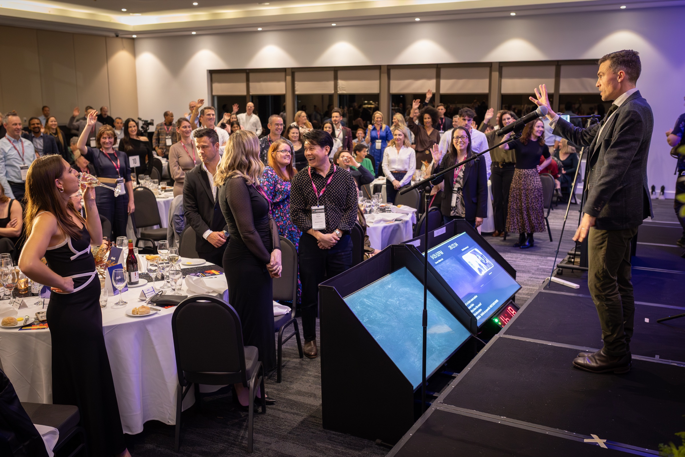 Andy Nunn speaking at a corporate event with audience participation in Melbourne
