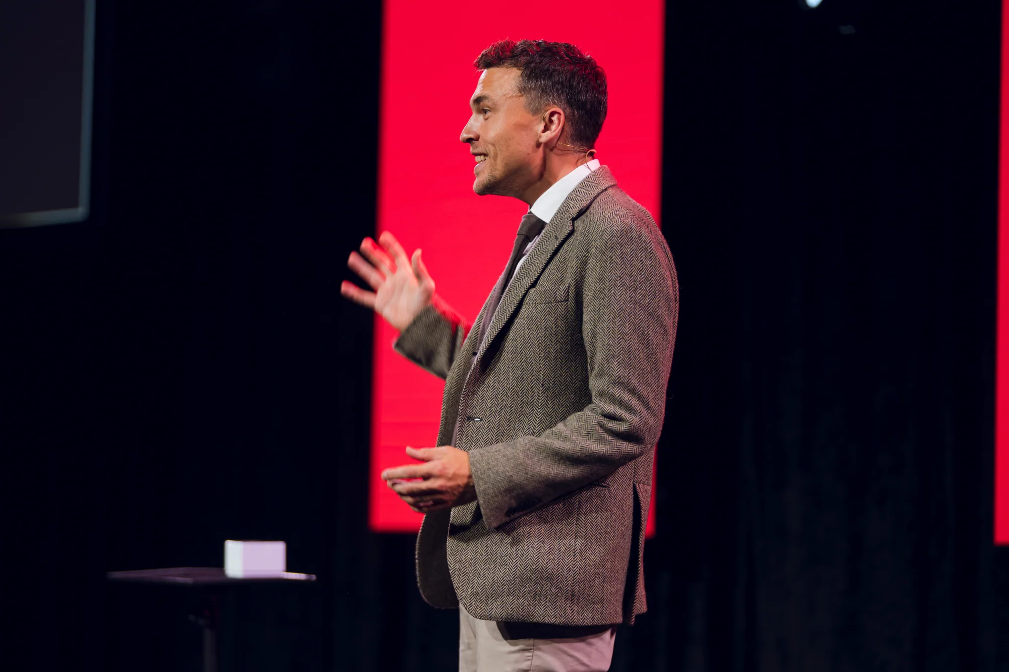 Andy Nunn presenting in profile on a corporate stage