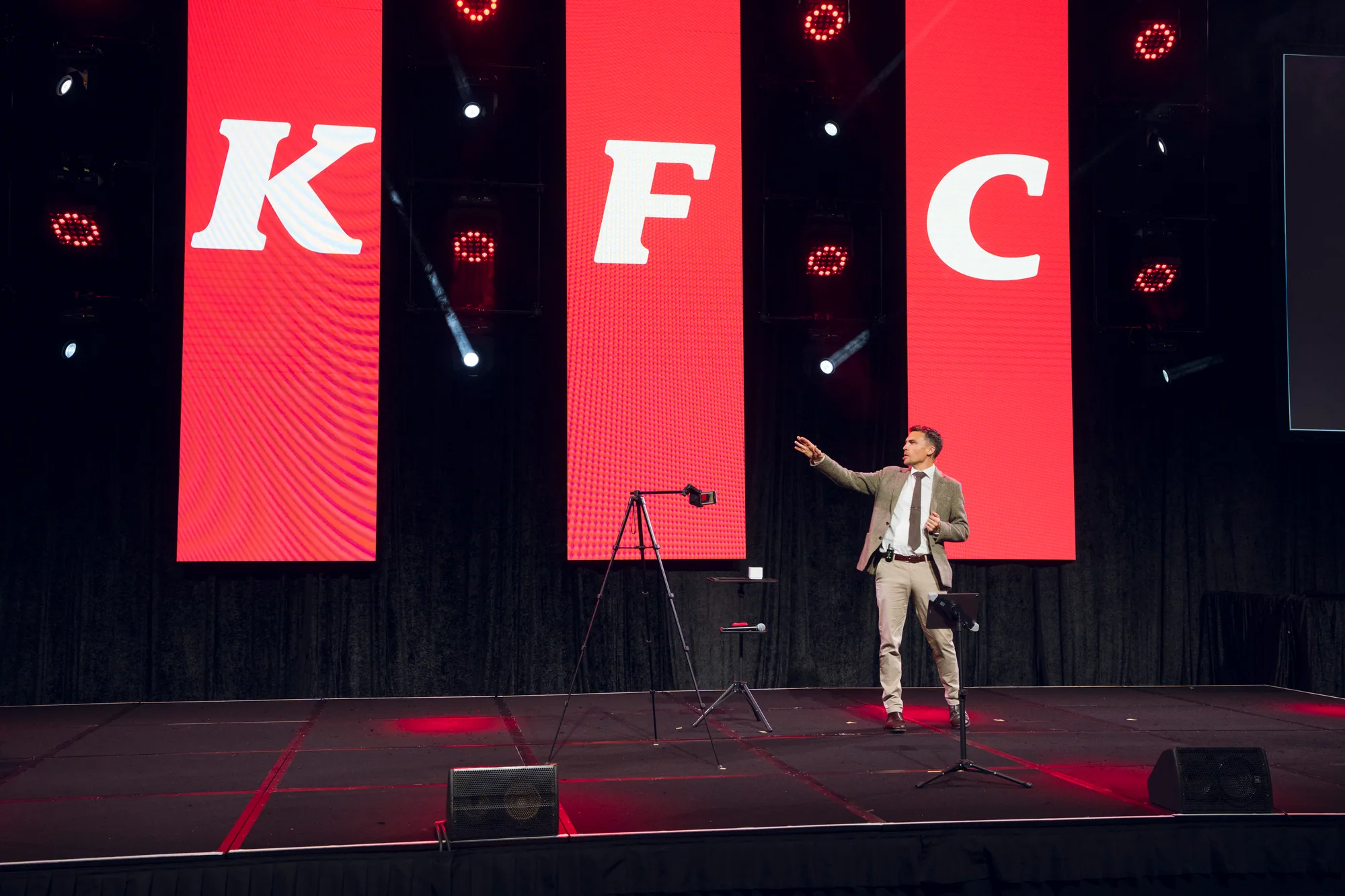 Andy Nunn speaking on a large corporate event stage