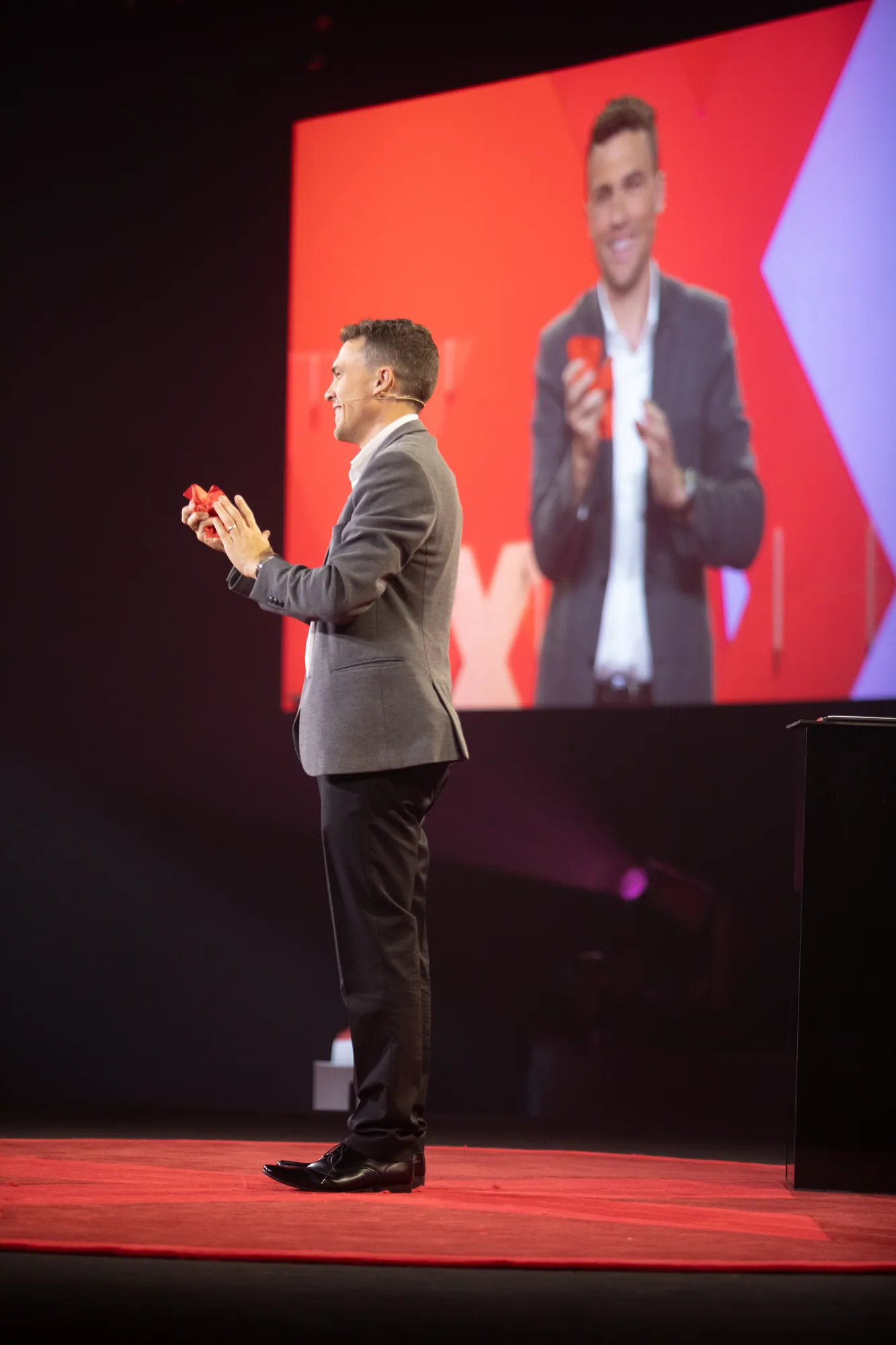 Andy Nunn presenting on a TEDx stage, shown as an example of his live speaking