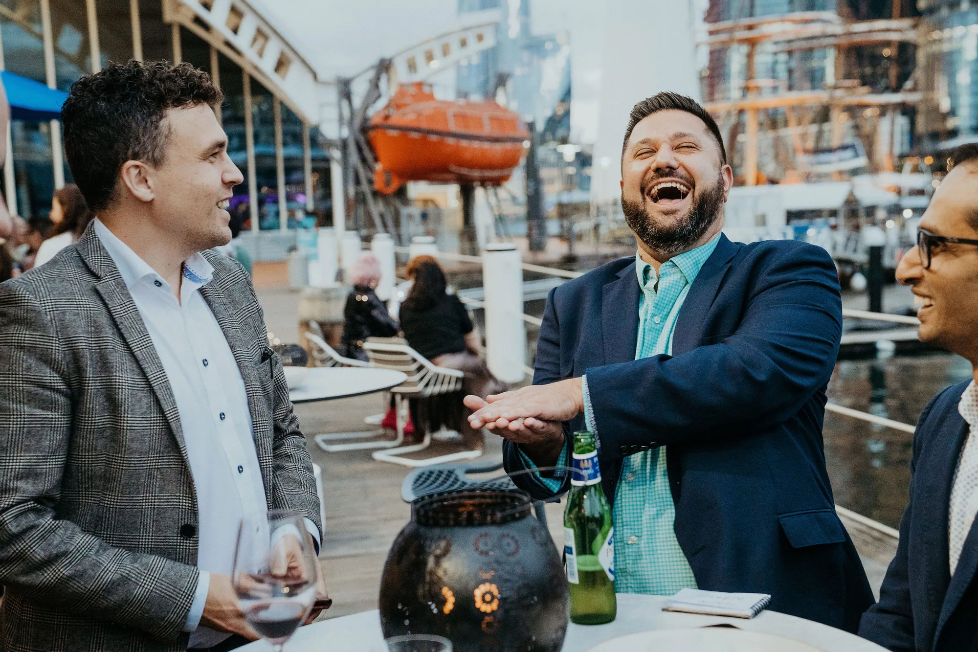 A corporate guest laughing during Andy Nunn's roving mentalism